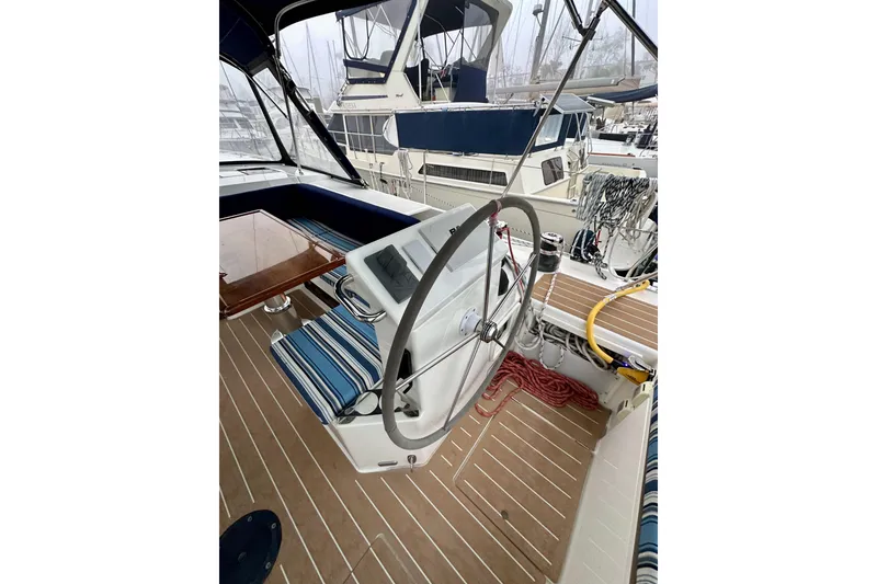 Slide: The Image of Steering wheel of a 2020 Bavaria C50 yacht with striped seating and nautical equipment. - 36