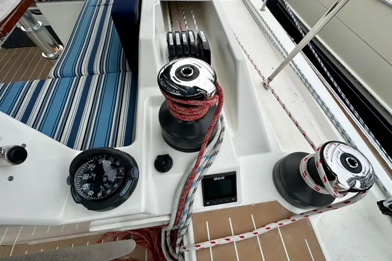 Slide: The Image of Cockpit of 2020 Bavaria C50 yacht with winches, compass, and striped seating. - 38