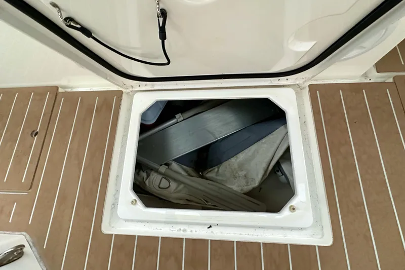 Slide: The Image of Open storage compartment on 2020 Bavaria C50 yacht deck, revealing interior contents. - 40