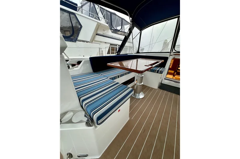 Slide: The Image of Interior of 2020 Bavaria C50 yacht with striped seating and wooden table. - 42
