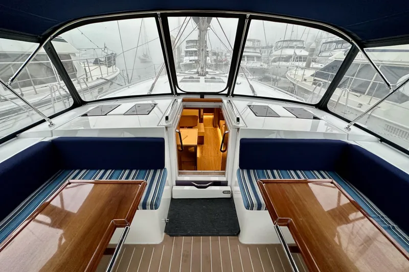 Slide: The Image of Interior view of 2020 Bavaria C50 yacht with elegant seating and wooden tables. - 44