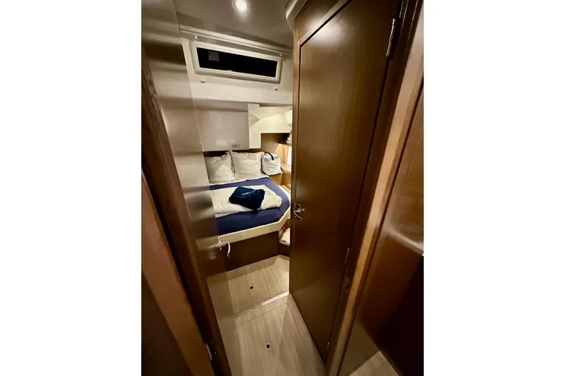 Slide: The Image of Interior cabin of 2020 Bavaria C50 yacht with cozy bed and wooden finish. - 50