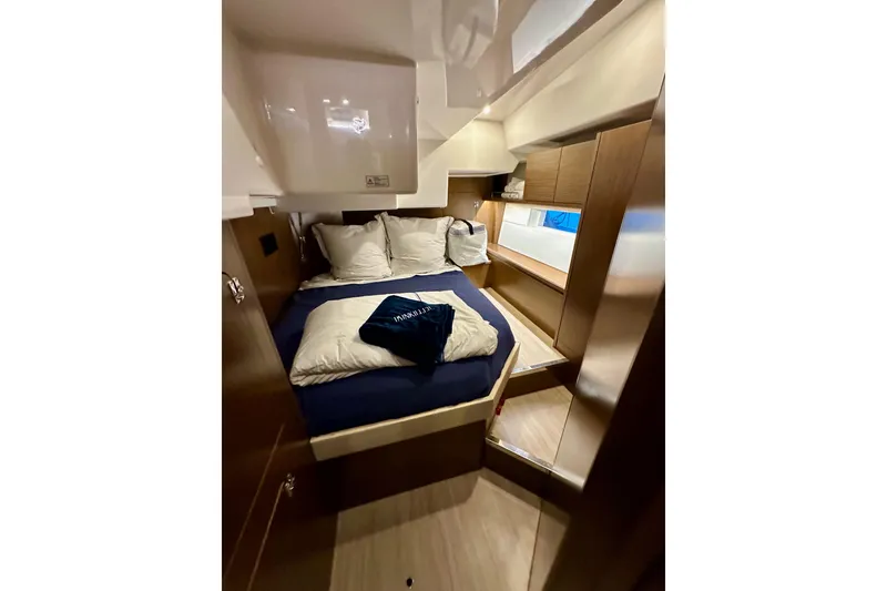 Slide: The Image of Luxurious cabin interior of 2020 Bavaria C50 yacht with cozy bedding and wooden finishes. - 51