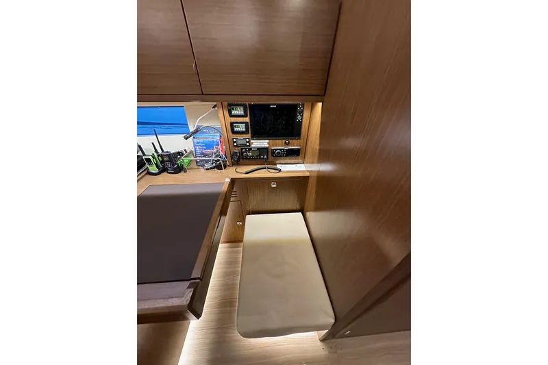 Slide: The Image of 2020 Bavaria C50 yacht interior with navigation station and wooden cabinetry. - 64