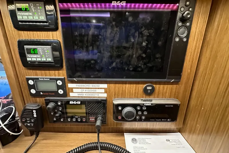 Slide: The Image of Control panel of a 2020 Bavaria C50 yacht with navigation and communication equipment. - 65