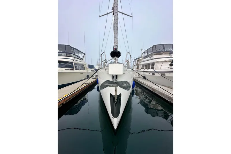 Slide: The Image of Bavaria C50 sailboat docked between yachts, 2020 model, in a marina setting. - 8