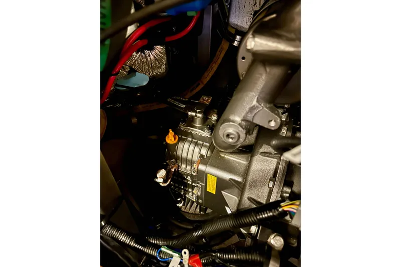 Slide: The Image of Engine compartment of a 2020 Bavaria C50 yacht, showcasing mechanical components and wiring. - 83