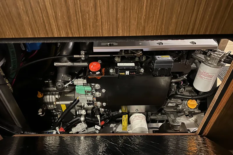 Slide: The Image of Engine compartment of a 2020 Bavaria C50 yacht, showcasing intricate mechanical components. - 84