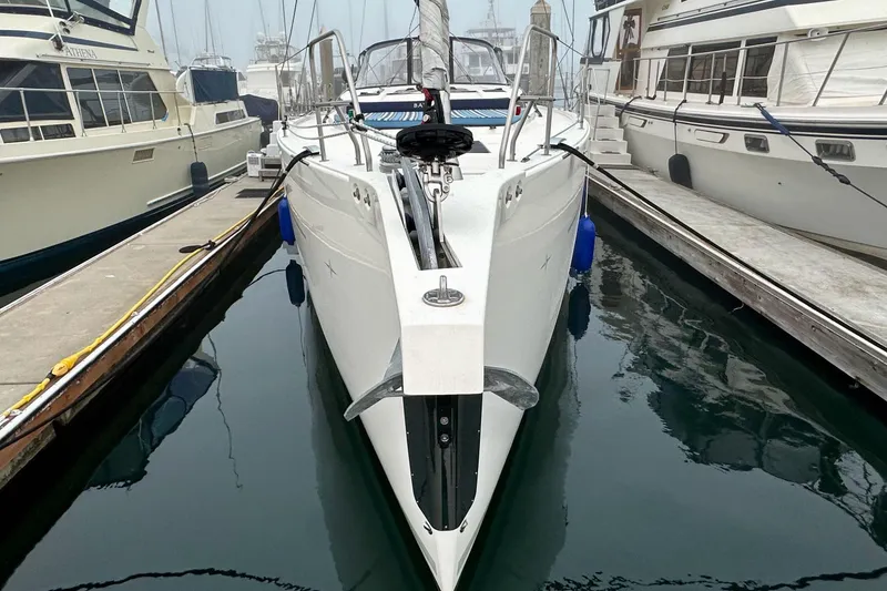 Slide: The Image of 2020 Bavaria C50 yacht docked between boats in a marina. - 9