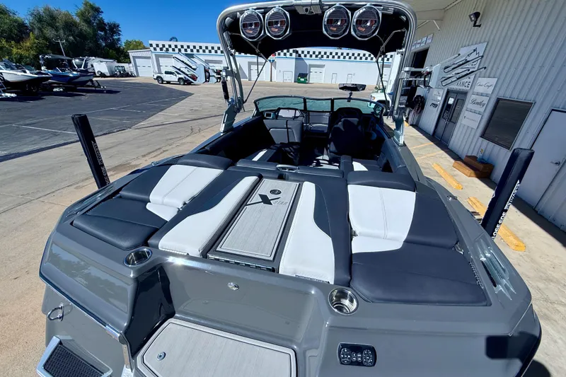 Slide: The Image of 2020 MasterCraft XStar boat with sleek interior design at a marina. - 12