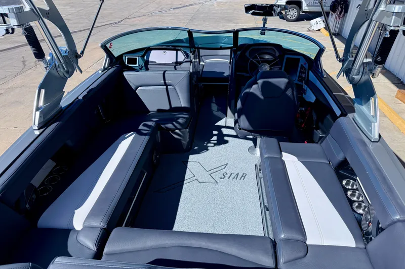 Slide: The Image of 2020 MasterCraft XStar boat interior with sleek seating and modern dashboard design. - 15