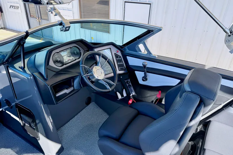 Slide: The Image of 2020 MasterCraft XStar boat interior with modern dashboard and steering wheel. - 16
