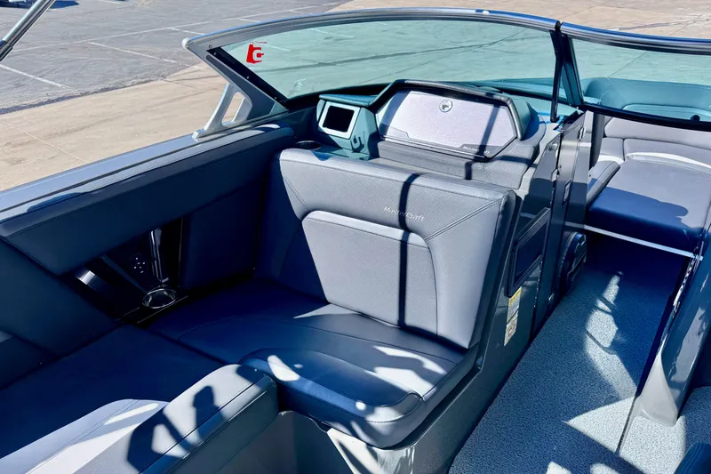 Slide: The Image of 2020 MasterCraft XStar boat interior with sleek seating and modern dashboard design. - 19