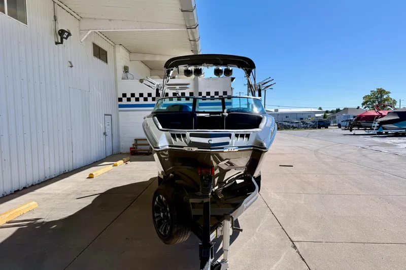 Slide: The Image of 2020 MasterCraft XStar boat on trailer in outdoor showroom. - 2