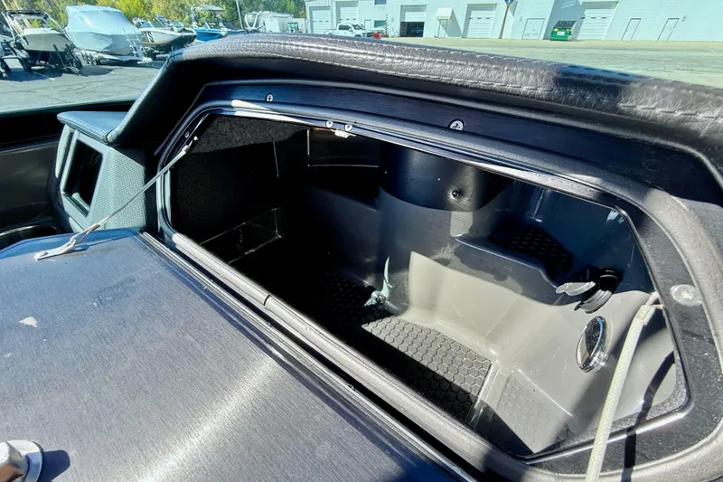 Slide: The Image of 2020 MasterCraft XStar boat storage compartment with open hatch, showcasing interior details. - 24