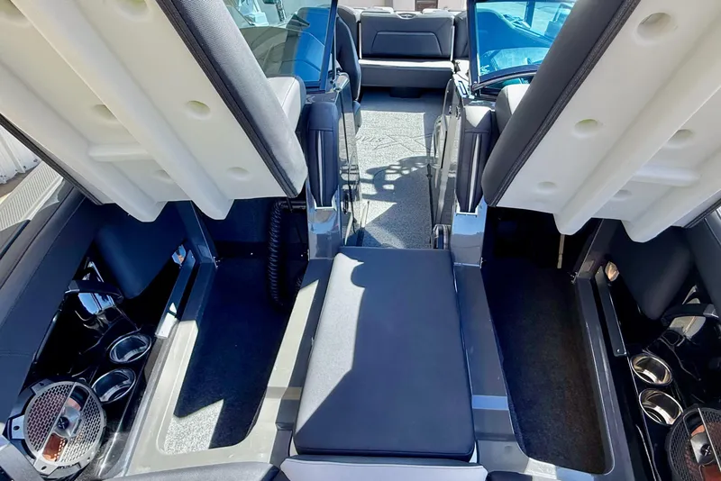 Slide: The Image of 2020 MasterCraft XStar interior with open storage compartments and cup holders. - 25