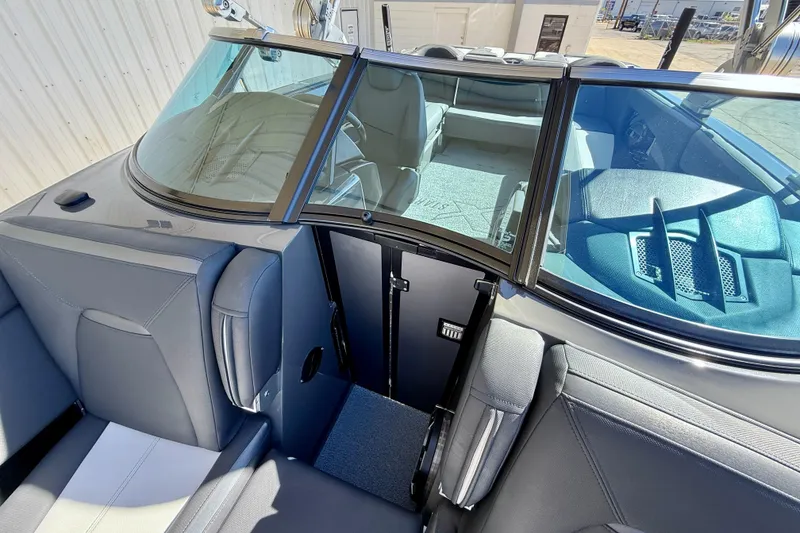 Slide: The Image of 2020 MasterCraft XStar boat interior with sleek seating and windshield design. - 27