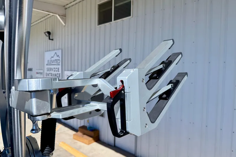 Slide: The Image of 2020 MasterCraft XStar wakeboard rack, silver metal, mounted on a boat near a service entrance. - 38