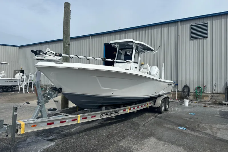 The Image of 2026 Blazer Bay Makaira 2800 boat on trailer, parked near palm trees. - 0