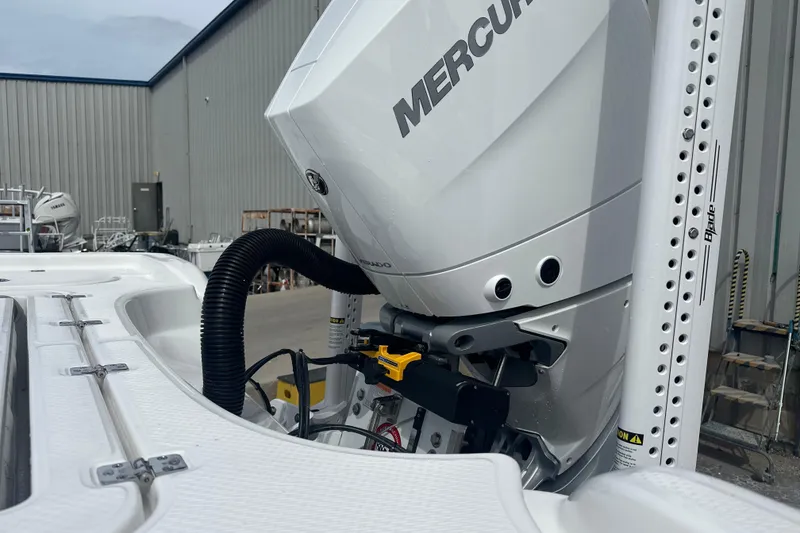 Slide: The Image of 2026 Blazer Bay Makaira 2800 boat at a dealership, showcasing rear deck and motor. - 11