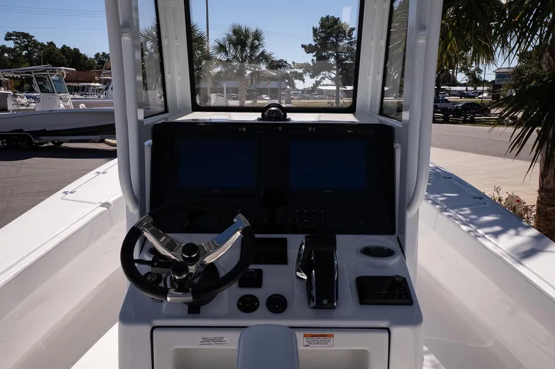 Slide: The Image of 2026 Blazer Bay Makaira 2800 boat console with steering wheel and dual screens. - 17