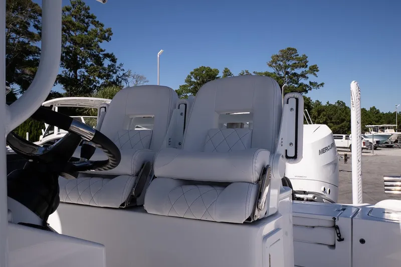 Slide: The Image of 2026 Blazer Bay Makaira 2800 boat with white leather seats and steering wheel. - 20