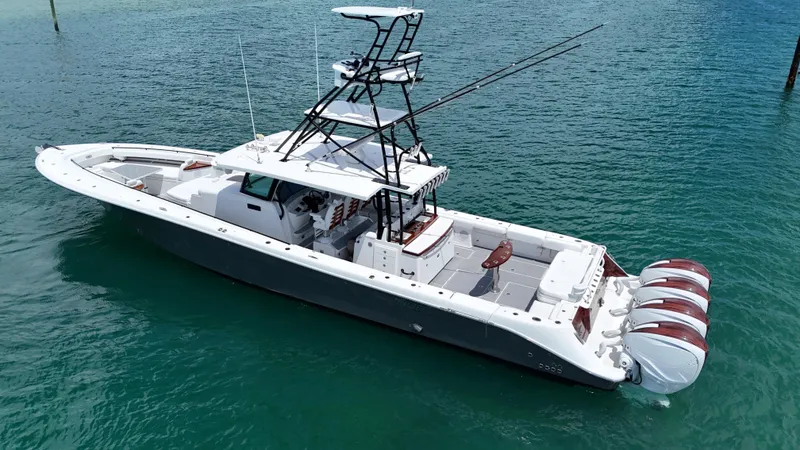 Slide: The Image of 2019 HCB 53 Sueños boat with multiple outboard engines on clear water. - 10