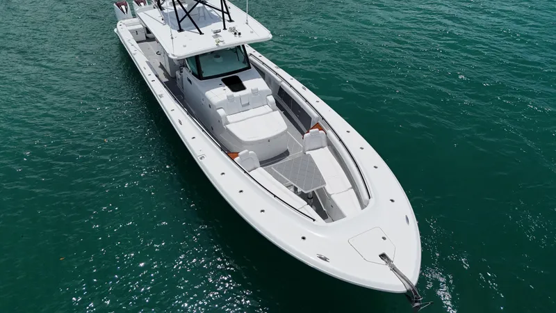 Slide: The Image of 2019 HCB 53 Sueños boat on clear blue water, aerial view. - 14