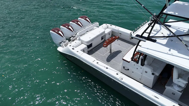 Slide: The Image of 2019 HCB 53 Sueños boat with four engines on turquoise water. - 15