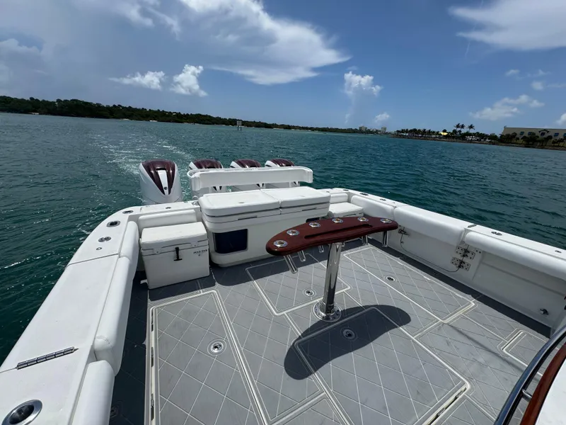 Slide: The Image of 2019 HCB 53 Sueños boat deck with seating, table, and ocean view. - 17