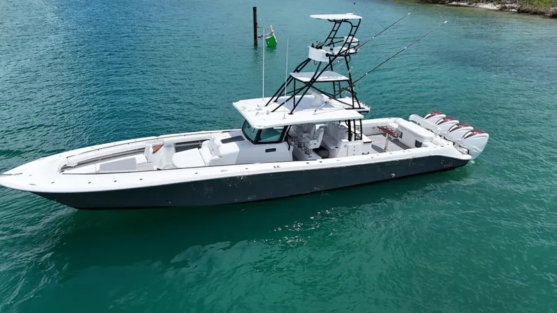 Slide: The Image of 2019 HCB 53 Sueños boat on turquoise water, featuring multiple outboard engines. - 2