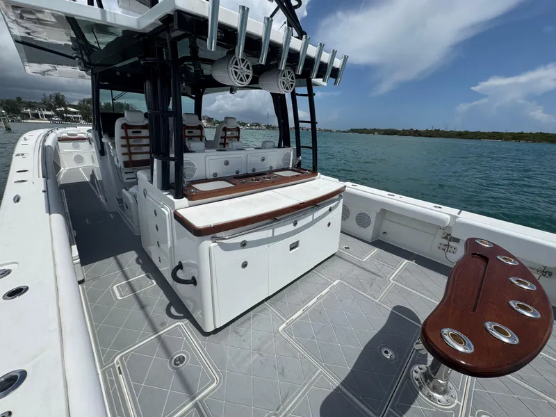Slide: The Image of 2019 HCB 53 Sueños boat with spacious deck and seating, docked by the water. - 20