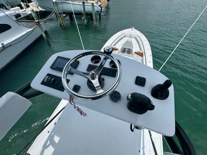 Slide: The Image of Helm of 2019 HCB 53 Sueños boat with steering wheel and controls. - 22