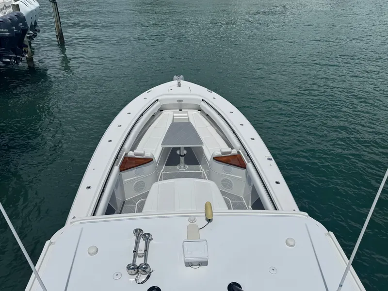 Slide: The Image of 2019 HCB 53 Sueños boat on water, viewed from above, showcasing sleek design and spacious deck. - 23