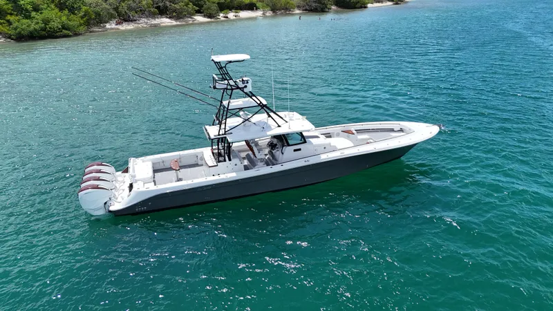 Slide: The Image of 2019 HCB 53 Sueños boat on clear blue water, featuring multiple outboard engines. - 3