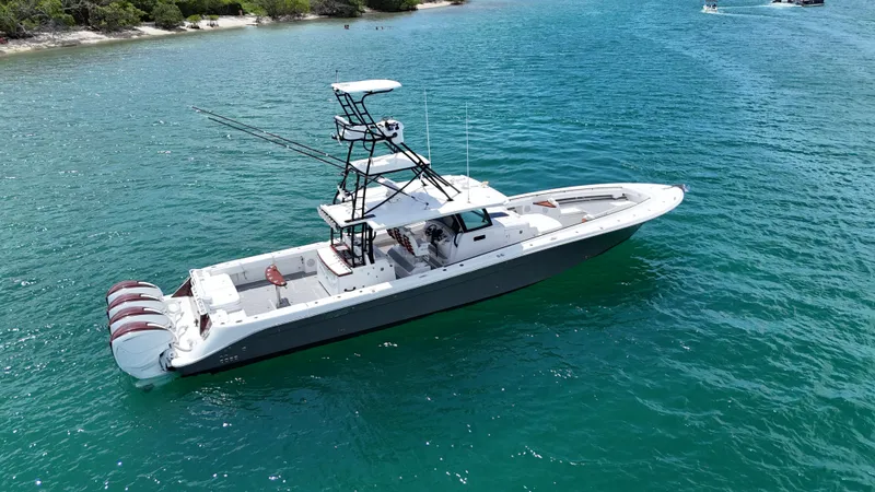 Slide: The Image of 2019 HCB 53 Sueños boat on clear blue water, featuring multiple outboard engines. - 5