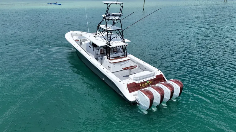 Slide: The Image of 2019 HCB 53 Sueños boat with multiple engines on clear blue water. - 7