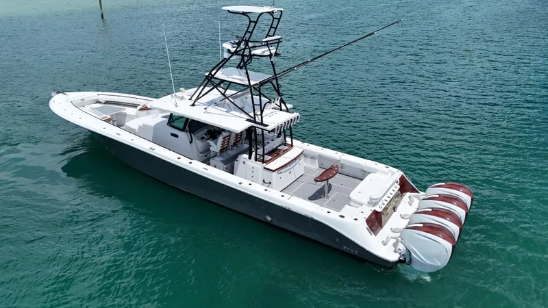 Slide: The Image of 2019 HCB 53 Sueños boat on clear turquoise water, featuring multiple outboard engines. - 9