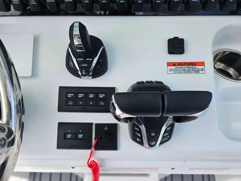 Slide: The Image of Control panel of 2025 Sea Hunt Ultra 305 SE boat with throttle and switches. - 16