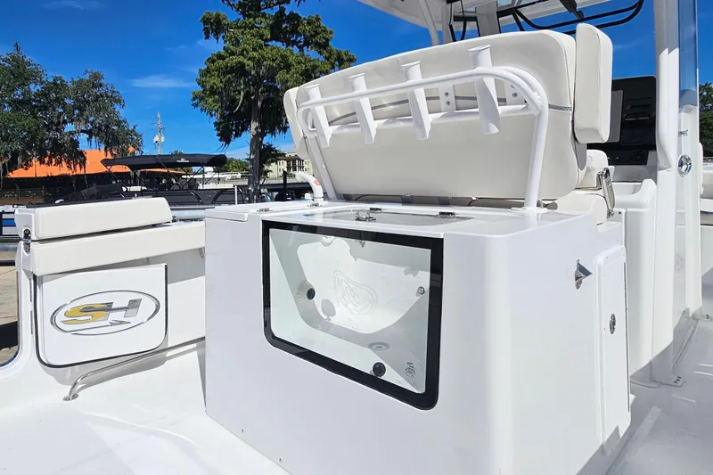 Slide: The Image of 2026 Sea Hunt Ultra 305 SE boat interior with seating and storage compartments. - 21