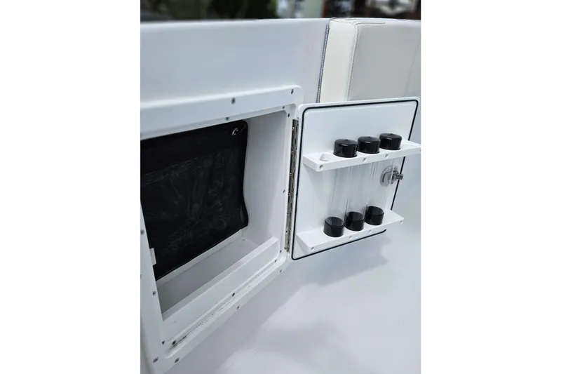 Slide: The Image of 2026 Sea Hunt Ultra 305 SE storage compartment with tube holders and netting. - 25