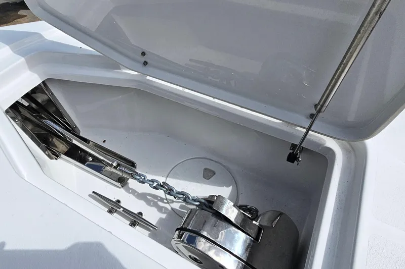 Slide: The Image of Anchor compartment of 2026 Sea Hunt Ultra 305 SE boat, featuring chain and winch. - 33
