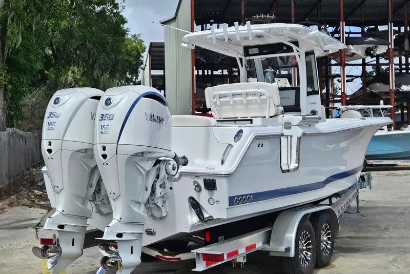 Slide: The Image of 2026 Sea Hunt Ultra 305 SE boat with dual Yamaha 350 engines on a trailer. - 40