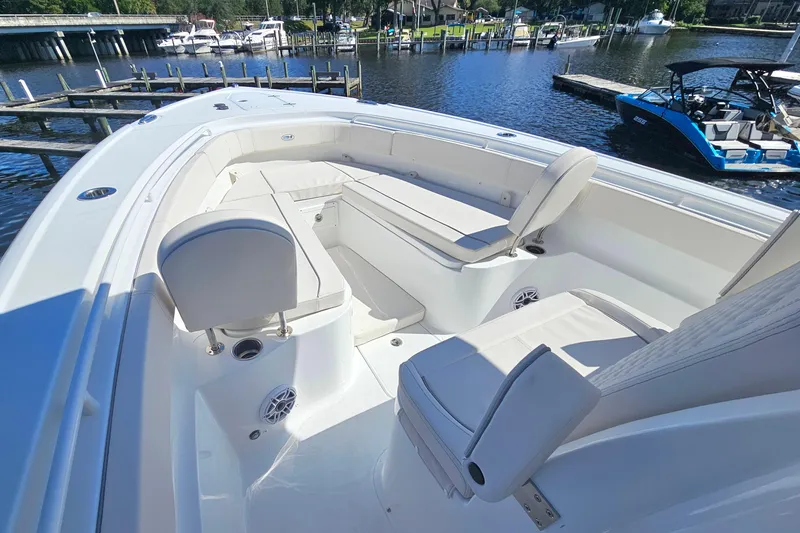 Slide: The Image of 2026 Sea Hunt Ultra 305 SE boat interior with white seating and waterfront view. - 6