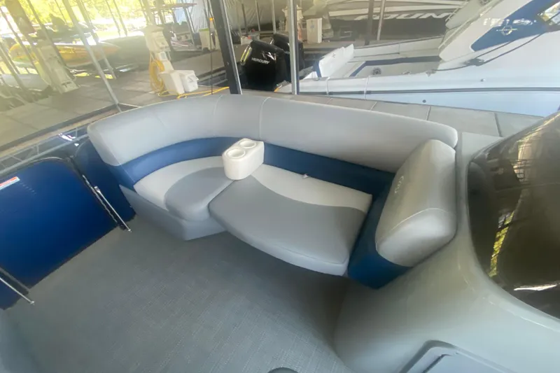 Slide: The Image of 2019 Manitou Aurora LE 23 RF VP boat interior with gray and blue seating. - 11