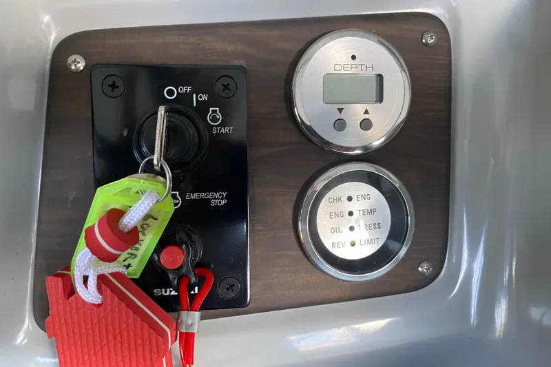 Slide: The Image of Control panel of 2019 Manitou Aurora LE 23 RF VP boat with key and gauges. - 15