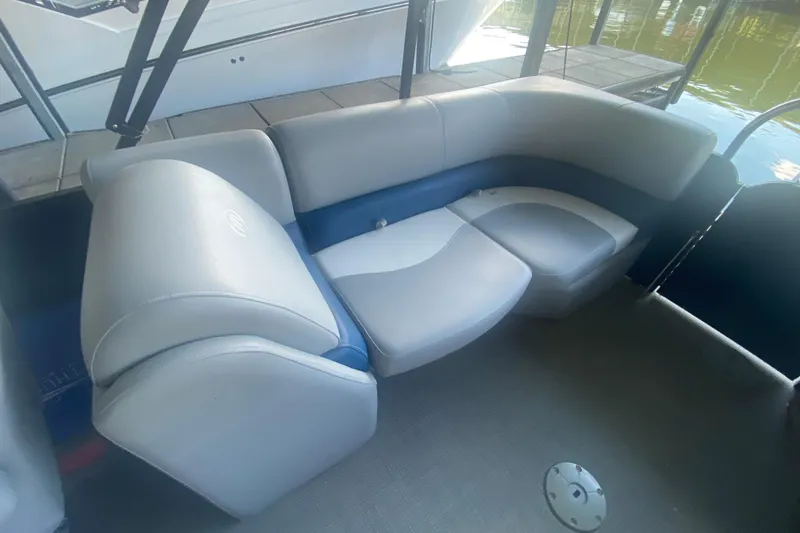 Slide: The Image of 2019 Manitou Aurora LE 23 RF VP boat interior with gray and blue seating. - 23