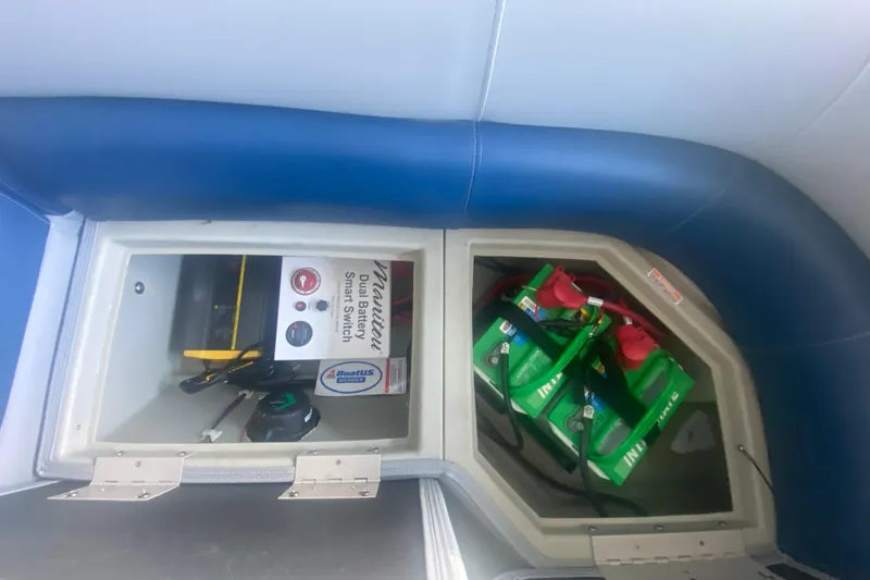 Slide: The Image of 2019 Manitou Aurora LE 23 RF VP boat battery compartment with dual battery smart switch. - 27