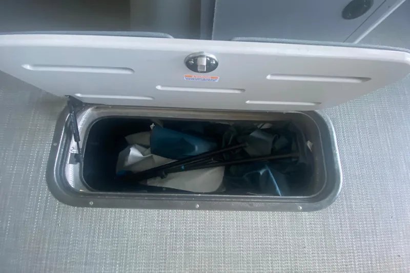 Slide: The Image of Open storage compartment in 2019 Manitou Aurora LE 23 RF VP boat. - 30
