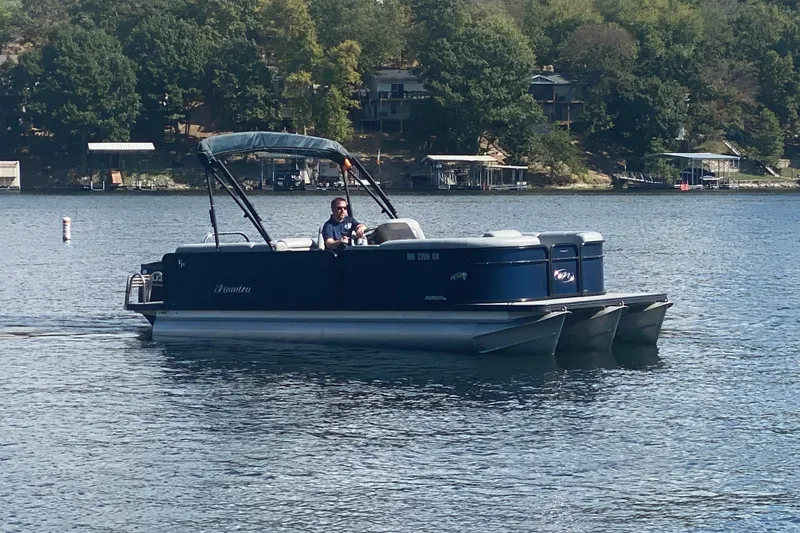 Slide: The Image of 2019 Manitou Aurora LE 23 RF VP pontoon boat on a serene lake. - 7